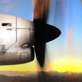 Side view of a plane propeller during a flight with sky and mountains background at sunrise  - PhotoDune Item for Sale