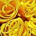 Close up of yellow and curvy balls of fettuccine before cooking Italian food - PhotoDune Item for Sale