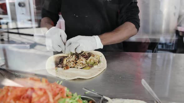 Preparation of shawarma in some street food restaurant in Tel Aviv. Making of doner kebab or kebap f