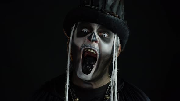 Man in Skeleton Halloween Costume Opening His Mouth, Showing Black Tongue, Dirty Teeth, Scaring You
