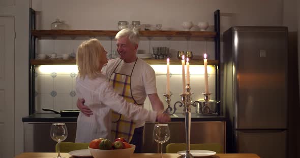 Happy Senior Couple in Love Dancing Having Romantic Dinner