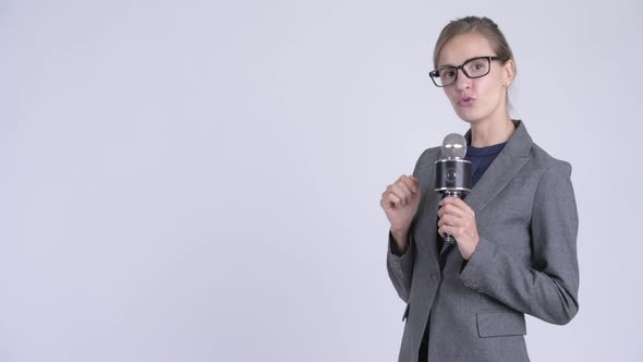 Young Beautiful Businesswoman As Newscaster Presenting Something