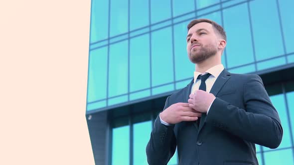 A Well Dressed Happy Bearded Office Corporate Male Executive Standing Outside a Modern Corporate