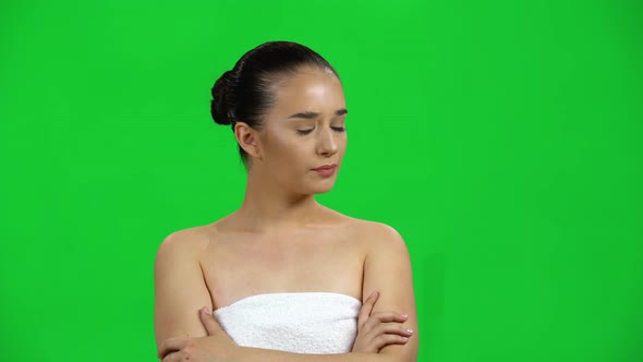 Girl in Towel Is Very Offended and Then Smiles on Green Screen at Studio