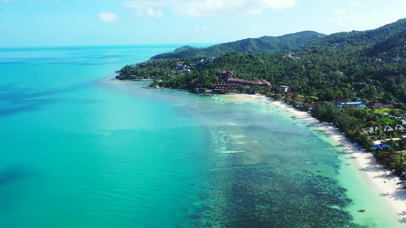 Aerial top down panorama of marine shore beach wildlife by blue green sea and white sandy background