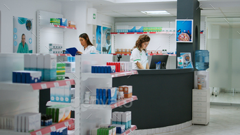 ounter to sell medicaments and pharmaceutics, looking at pharmaceutical products and boxes of pills. Checking drugs at pharmacy shop.