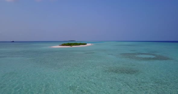 Wide above travel shot of a white sandy paradise beach and blue sea background in colourful 4K