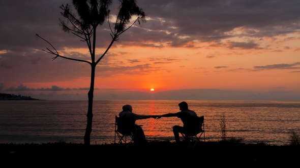 Happy Couple Watching The Sunset