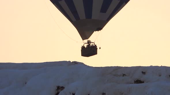 Hot Air Balloons in White Travertines of Pamukkale, a Touristic Natural World Heritage Site