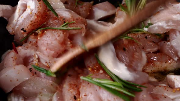 Sliced Pieces of Chicken Fillet Fried in Pan in Vegetable Oil with Rosemary and Spices