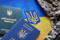 Ukrainian military ID and foreign passport on fabric with texture of pixeled camouflage - PhotoDune Item for Sale