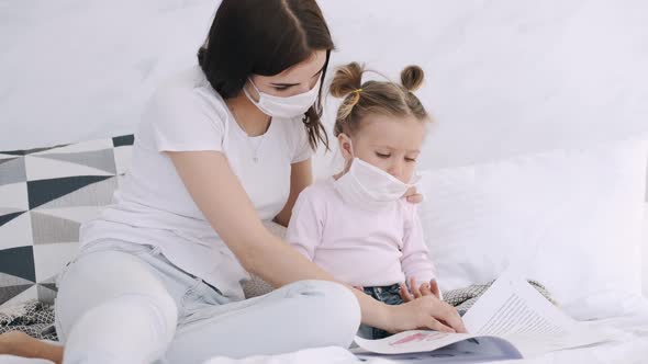 Mother Is Putting a Mask on Daughter's Face