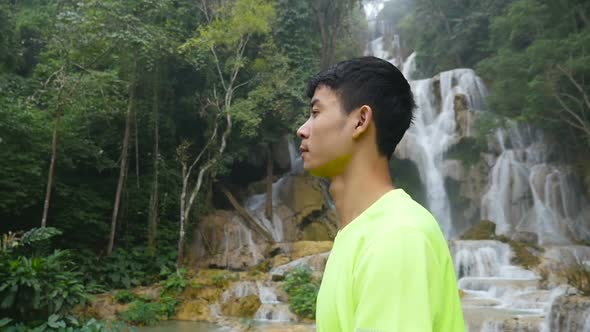 Man Walking, Waterfall at the Background