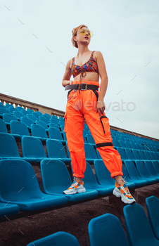 oking away while standing on stadium seats while representing urban lifestyle
