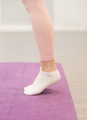 woman legs wearing leggings and sport socks standing on yoga mat. woman stands on tiptoe  - PhotoDune Item for Sale