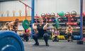 Woman weightlifting while her gym mates cheering her on - PhotoDune Item for Sale