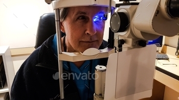  pressures and looking at the optic nerve with medical equipment. 
,