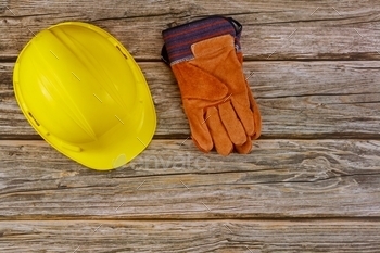  protective hard hat safety gloves on wooden background