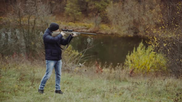 Hunter aiming for wildlife. Close up of hunter aiming down his rifle in autumn season