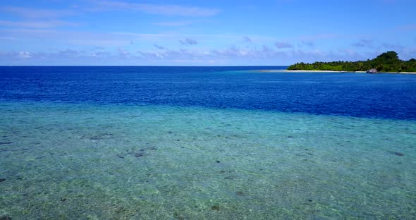 Wide above copy space shot of a white sand paradise beach and aqua blue ocean background in best qua