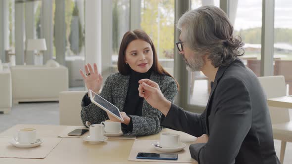 Business Couple Talking At Restaurant