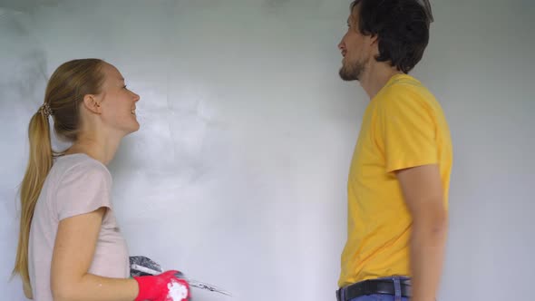 A Young Man and Woman are Doing Walls Renovation in Their House