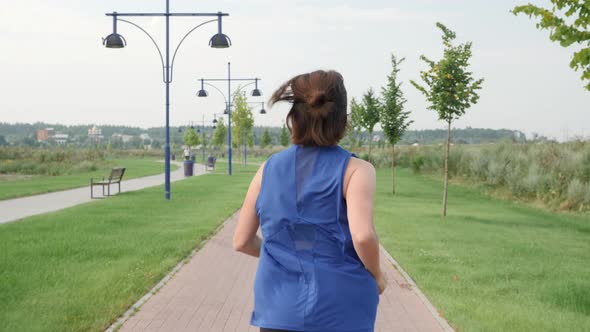 Woman jogging in park in the morning