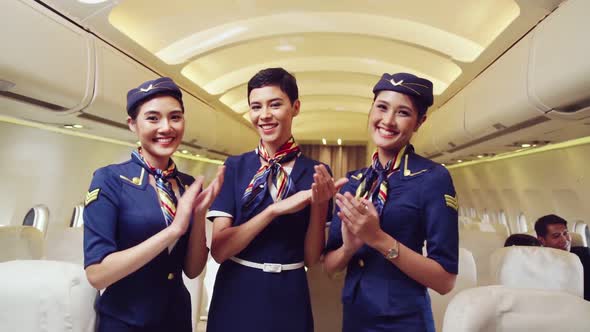 Cabin Crew Clapping Hands in Airplane