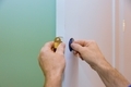 Handyman installing the door lock in the worker's hands new door locker - PhotoDune Item for Sale