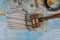 Court wooden gavel and money on blue background. - PhotoDune Item for Sale