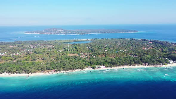 Daytime aerial abstract shot of a white sand paradise beach and blue water background 