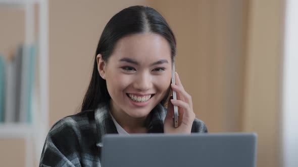 Happy Smiling Asian Girl Korean Female Freelancer Chatting with Friends on Phone Answering Call