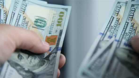 Businessman Counting Hundred Dollar Bills