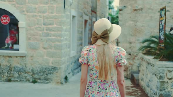 Graceful Woman Walking the Streets of a Medieval City