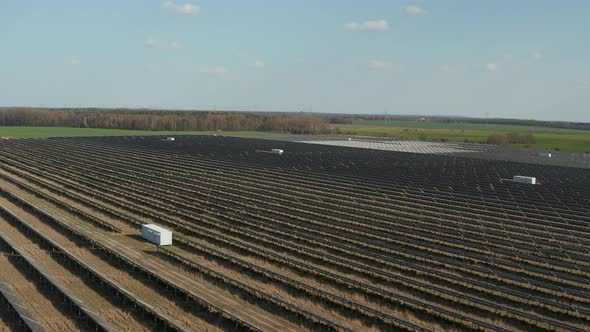 AERIAL: Wide View of Multiple Countless Solar Panels That Produce Green, Environmentally Friendly