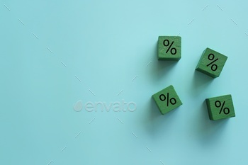 h indebtedness. Savings on shopping purchases. Discounts and promotions concept. Wooden cubes and percent sign with copy space