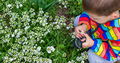 The child looks through a magnifying glass at the flowers Zoom in. - PhotoDune Item for Sale