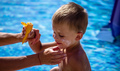 The mother smeared sunscreen on the child's face. Selective focus. - PhotoDune Item for Sale