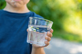 The child drinks water from a glass. Selective focus. - PhotoDune Item for Sale