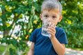 The child drinks water from a glass. Selective focus. - PhotoDune Item for Sale