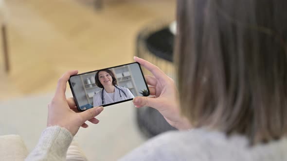 Female Doctor Talking During Video Chat in Smartphone Screen