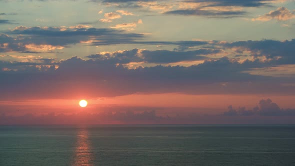 Colorful sunset at the sea. Against the background of the sea, sun goes down