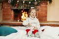 Little girl sitting on Christmas or New Year's eve at home - PhotoDune Item for Sale