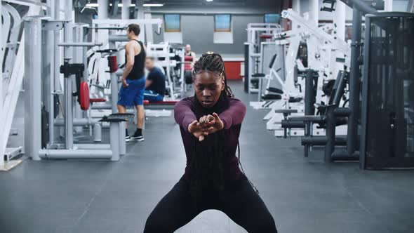 A Black Woman Warming Up in the Gym