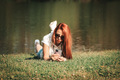 Beautiful girl with red hair laying on the grass  - PhotoDune Item for Sale