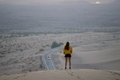 Woman stands on top of a sand dune in the desert thoughtful thinking about life and mental health - PhotoDune Item for Sale