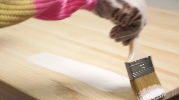 Woman Painting Wooden Table in White Color