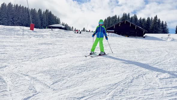 Cute 10 Years Old Boy Skier Racing Fast Down Slope