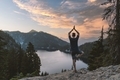 Man doing tree yoga pose overlooking an alpine lake near sunset in the mountains. - PhotoDune Item for Sale