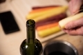 Wine bottle on kitchen counter while peeling carrots - PhotoDune Item for Sale